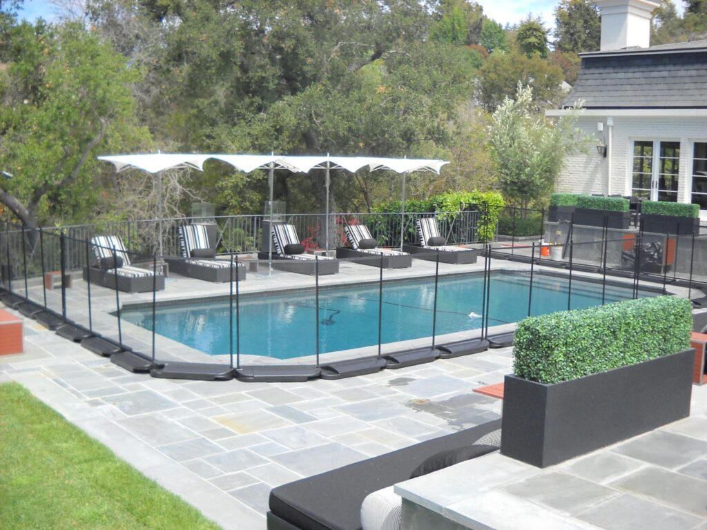 Pool area with safety fence and loungers