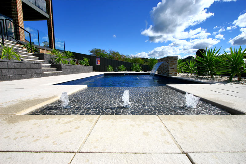 Modern pool with water features.