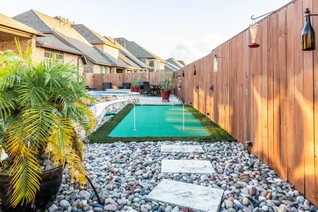 Backyard putting green with landscaping.