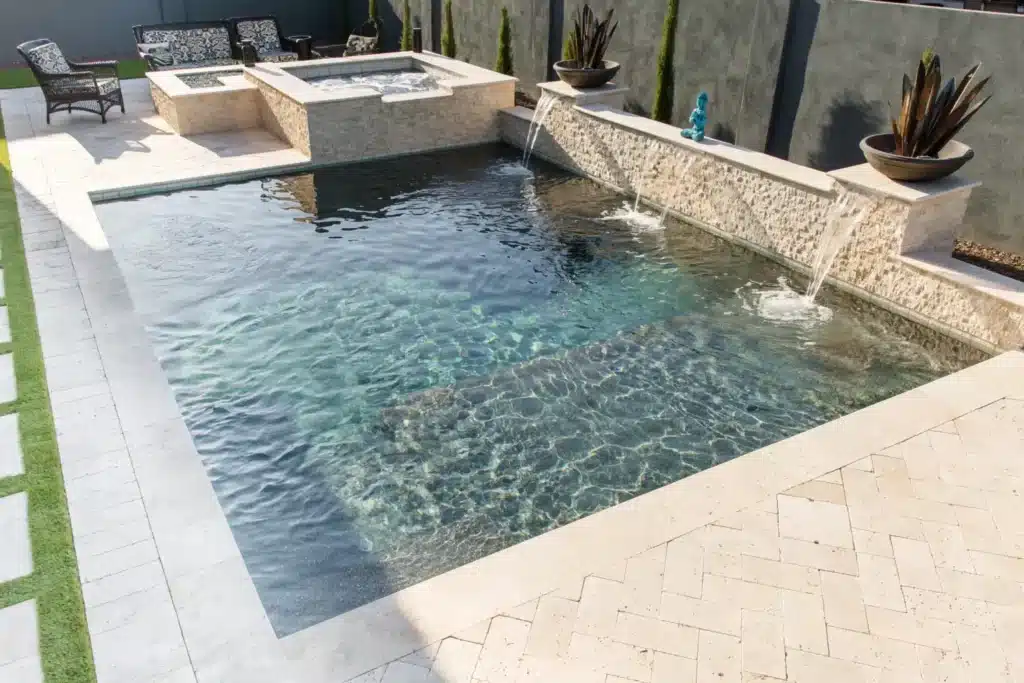 Modern pool with water features and landscaping