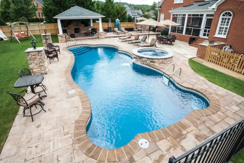 Elegant pool with spa and seating.