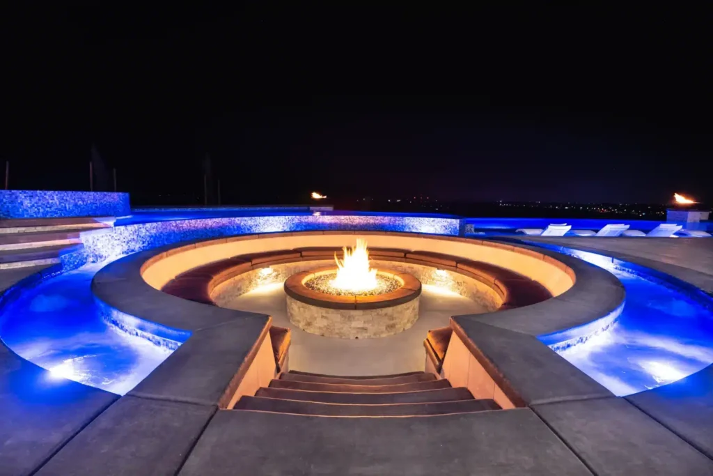 Elegant fire pit with illuminated pool.